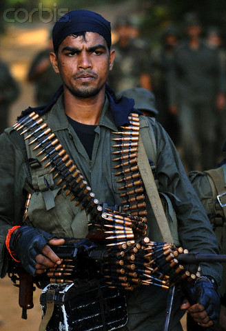 An SL Army soldier moves in on Palampeddi village, in north western Mannar, soon after its capture in July 2008. -- Image by © Stringer/Reuters/Corbis